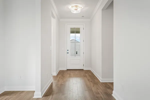 a view of a hallway with wooden floor