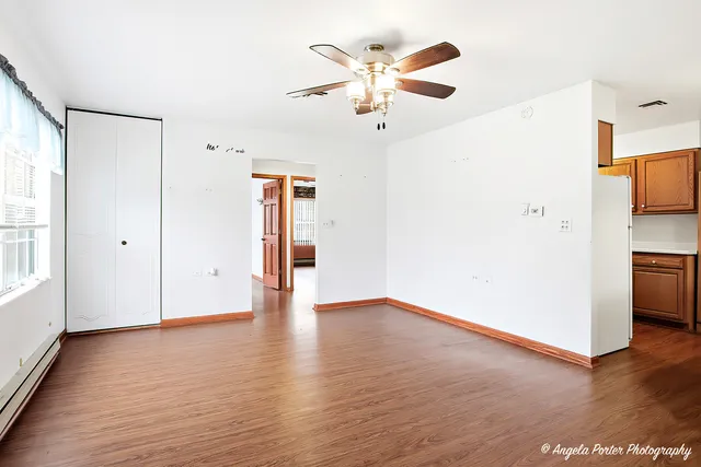 a view of an empty room with wooden floor