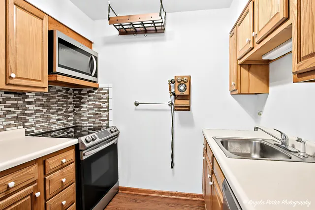a kitchen with stainless steel appliances a sink stove and refrigerator