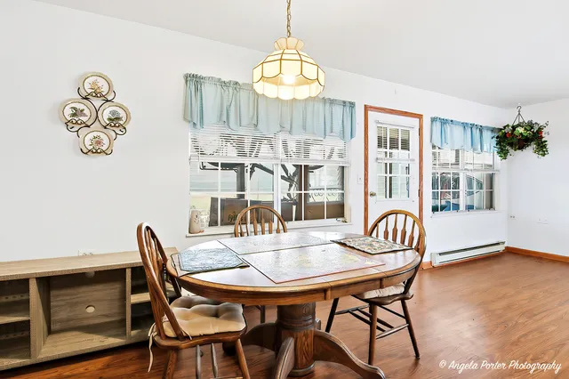 a view of a dining room with furniture window and wooden floor