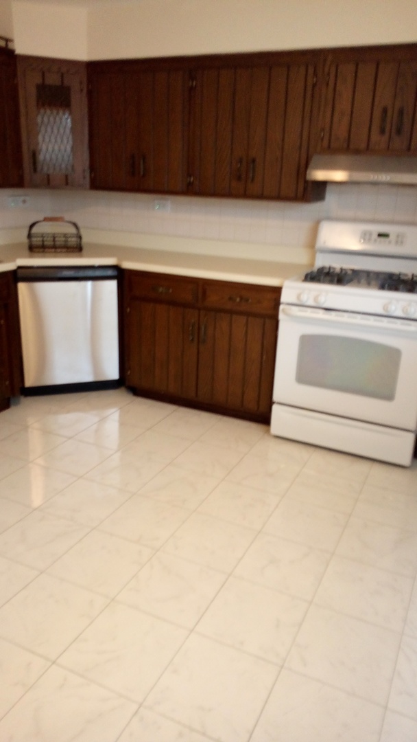 Undisclosed Address Chicago, IL 60630 - Photo 1 of 15 a kitchen with stainless steel appliances a stove a sink and a microwave