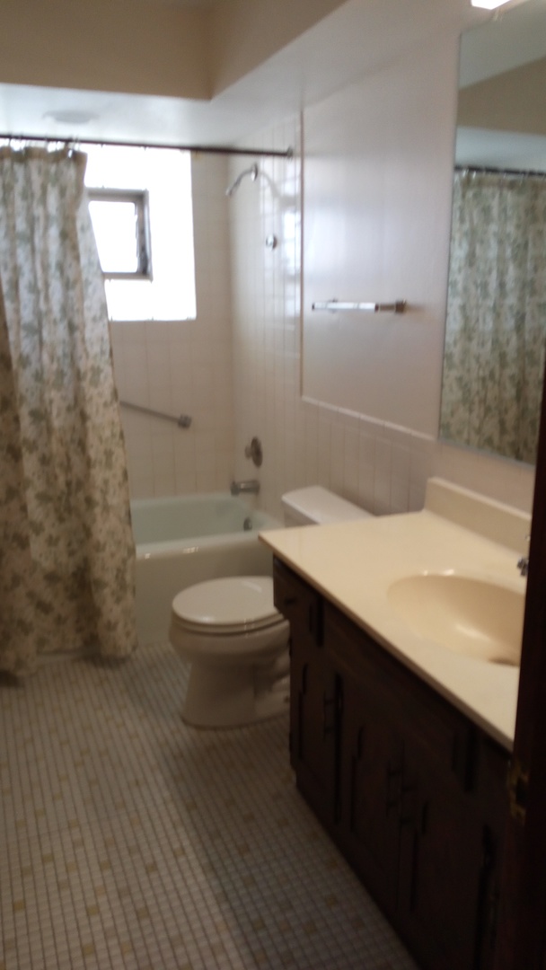 Undisclosed Address Chicago, IL 60630 - Photo 2 of 15 a bathroom with a sink a toilet and shower