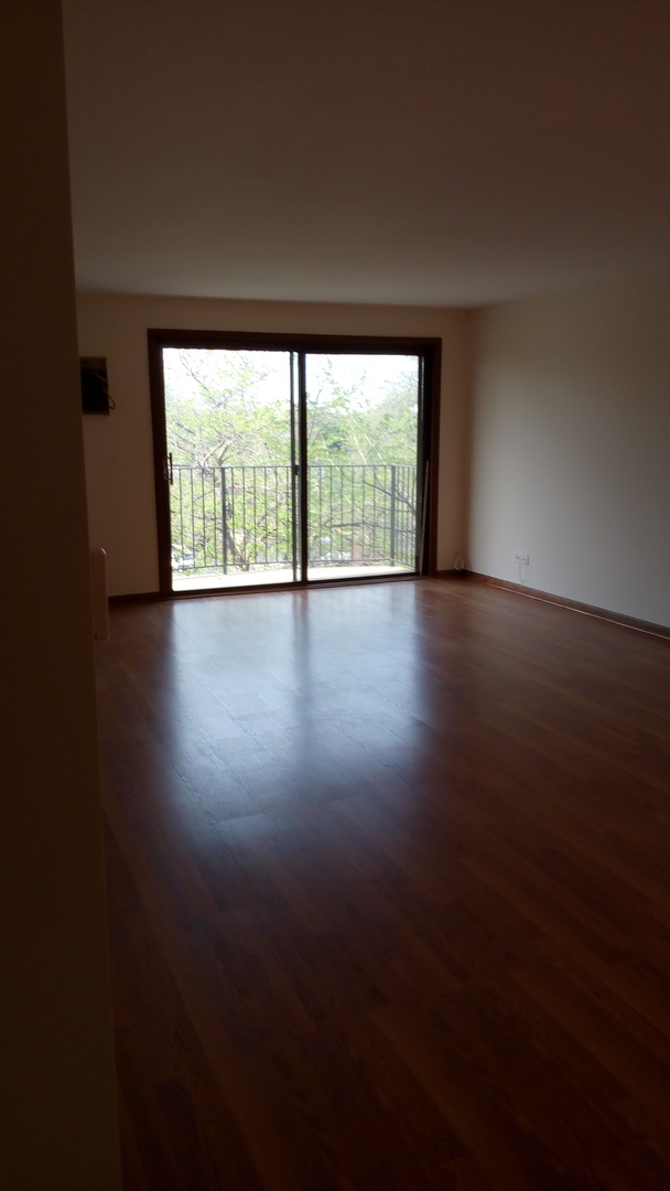 Undisclosed Address Chicago, IL 60630 - Photo 10 of 15 a view of an empty room with wooden floor and a window