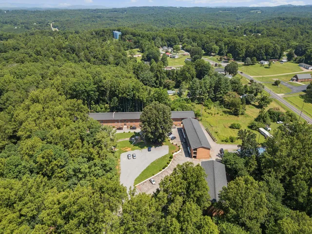 an aerial view of a house with a yard