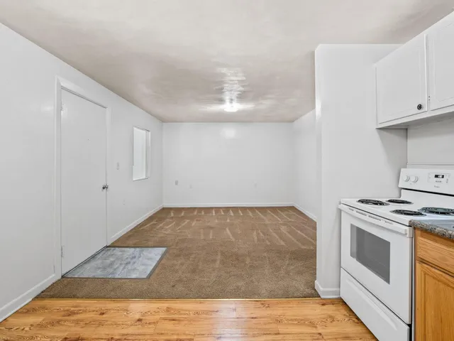 a kitchen with a stove and white cabinets
