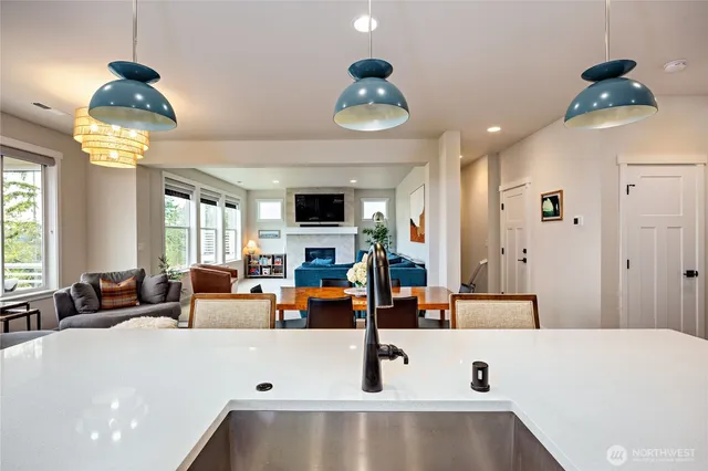 a large living room with a large bed and chandelier