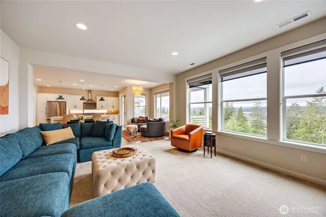a living room with furniture and large windows