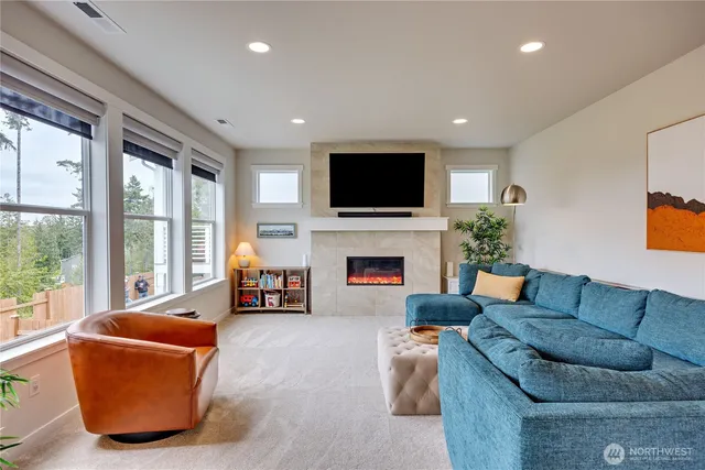 a living room with fireplace furniture and a flat screen tv