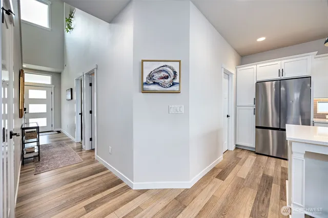 a view of a refrigerator in kitchen and wooden floor