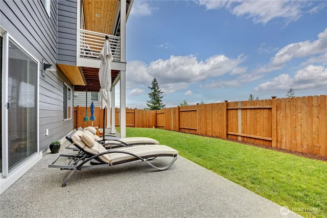 a view of a patio with a table and chairs and couches