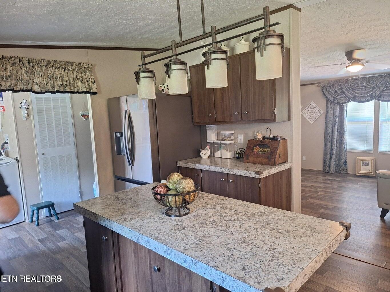 1450 Belltown Road Tellico Plains, TN 37385 - Photo 26 of 32 a kitchen with stainless steel appliances granite countertop a sink refrigerator and stove