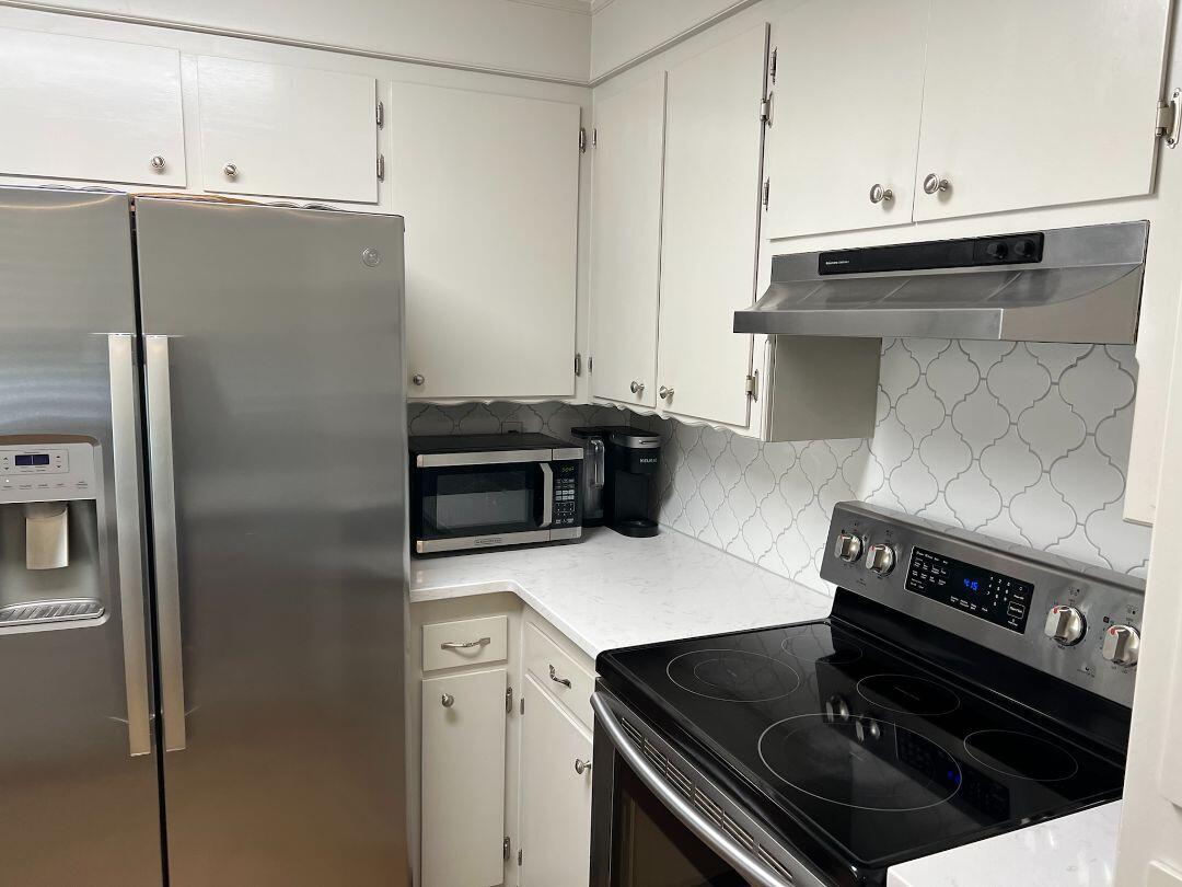 9733 Hidden Lane Palo Cedro, CA 96073 - Photo 11 of 63 a kitchen with a stove and a refrigerator