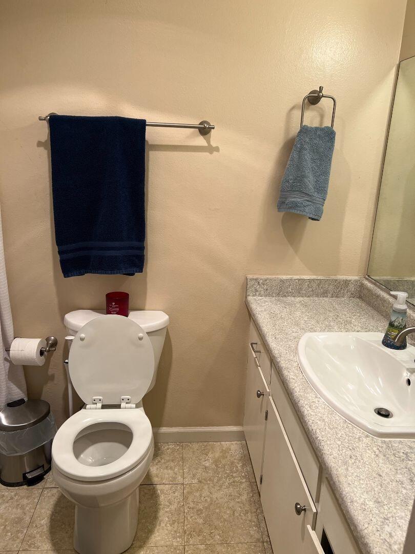 9733 Hidden Lane Palo Cedro, CA 96073 - Photo 19 of 63 a bathroom with a granite countertop toilet sink and mirror