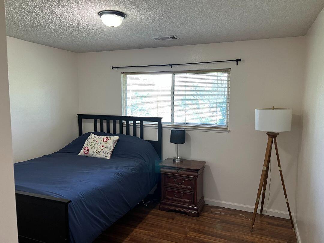 9733 Hidden Lane Palo Cedro, CA 96073 - Photo 22 of 63 a bedroom with a bed and a flat tv screen on the dresser