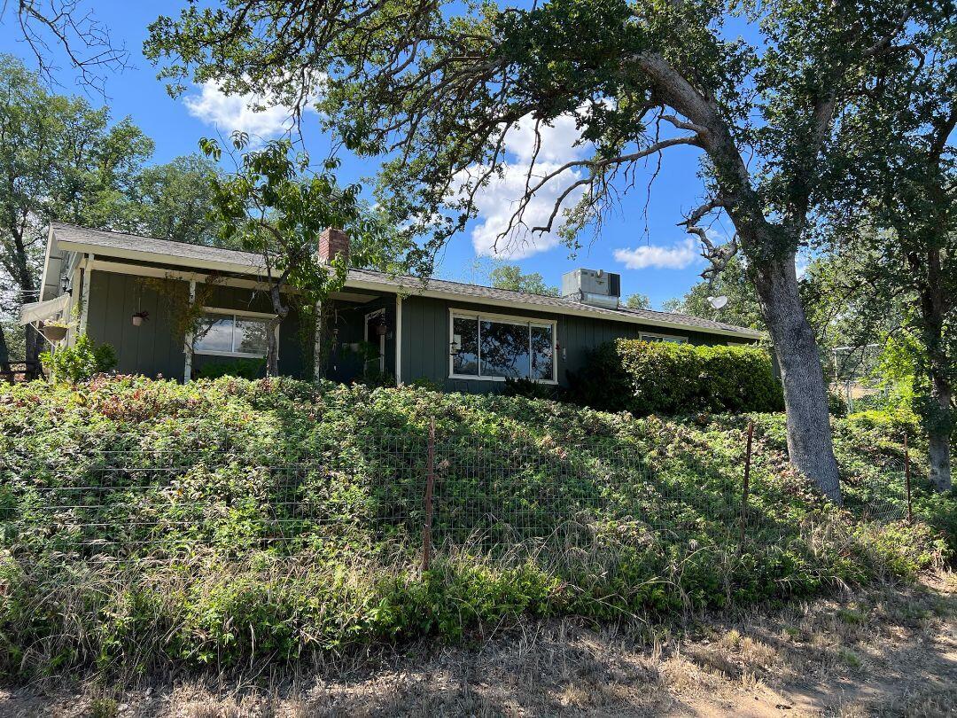 9733 Hidden Lane Palo Cedro, CA 96073 - Photo 3 of 63 a front view of house with a garden
