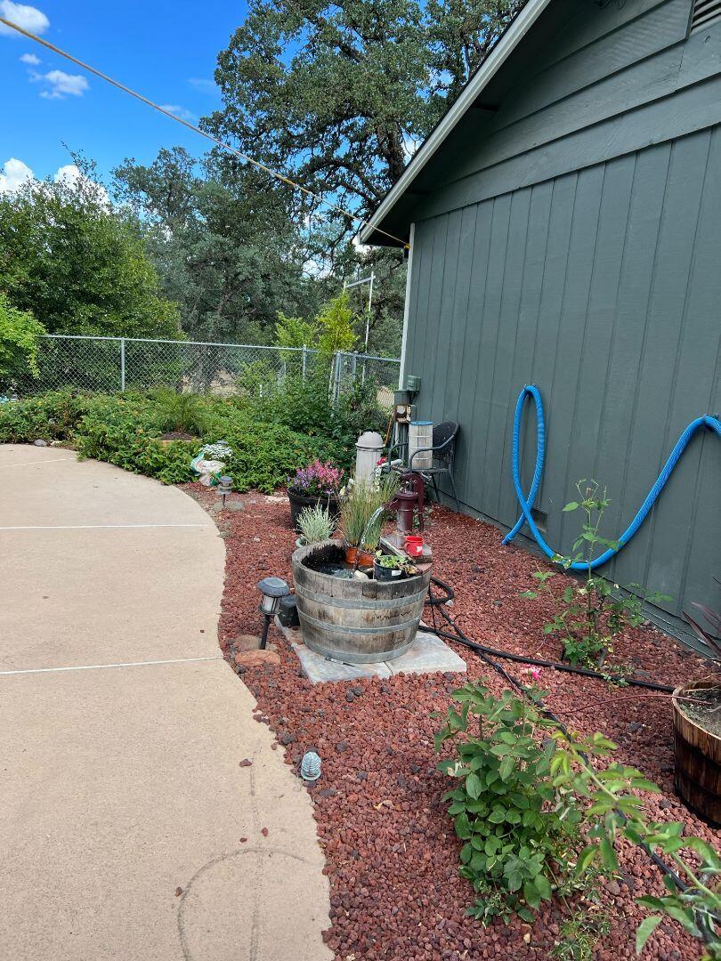 9733 Hidden Lane Palo Cedro, CA 96073 - Photo 36 of 63 a view of a chair and fire pit in the backyard with a small pool