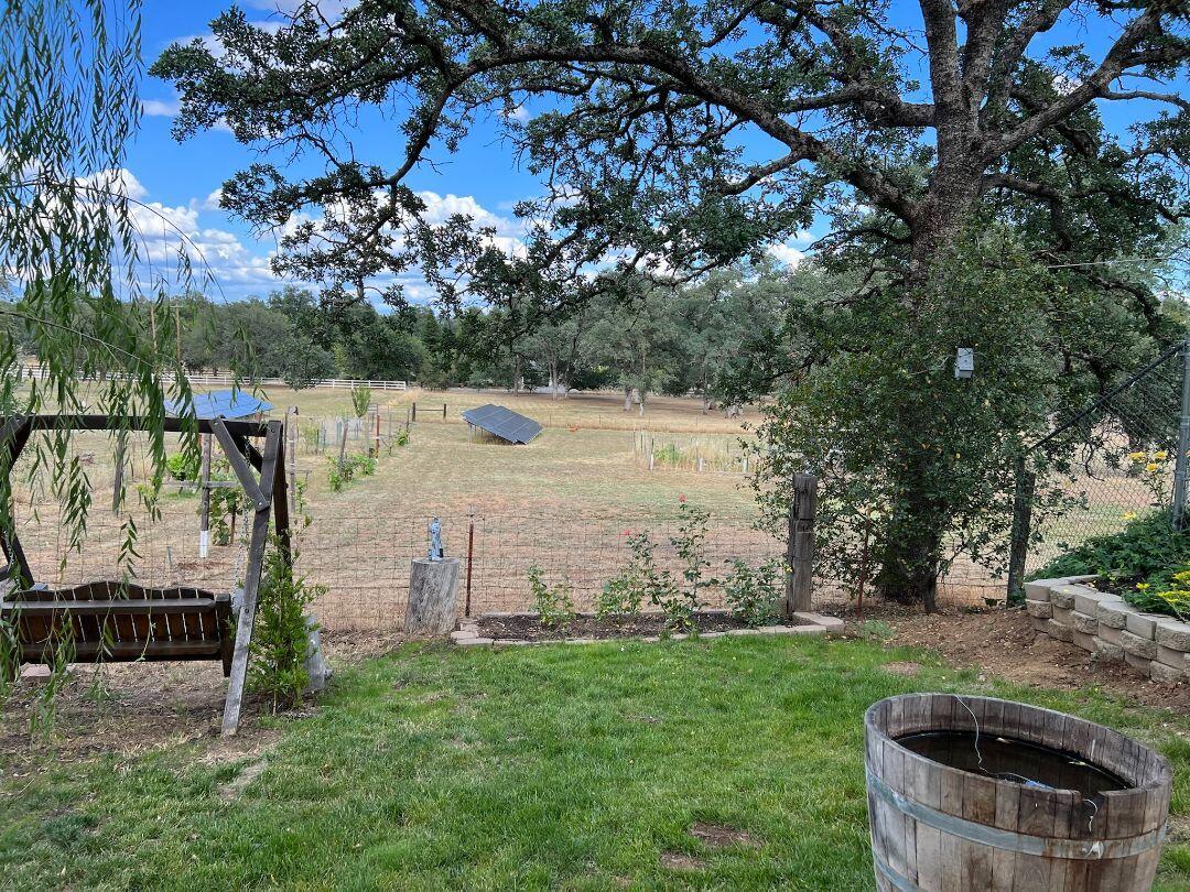 9733 Hidden Lane Palo Cedro, CA 96073 - Photo 45 of 63 a view of a garden with a fountain