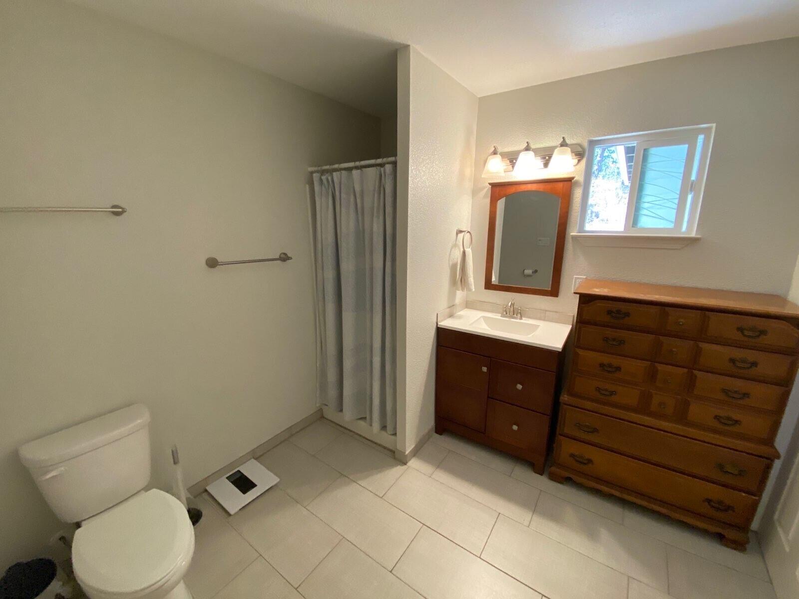 9733 Hidden Lane Palo Cedro, CA 96073 - Photo 53 of 63 a bathroom with a toilet a sink and mirror