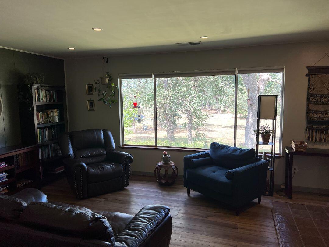 9733 Hidden Lane Palo Cedro, CA 96073 - Photo 6 of 63 a living room with furniture and a flat screen tv