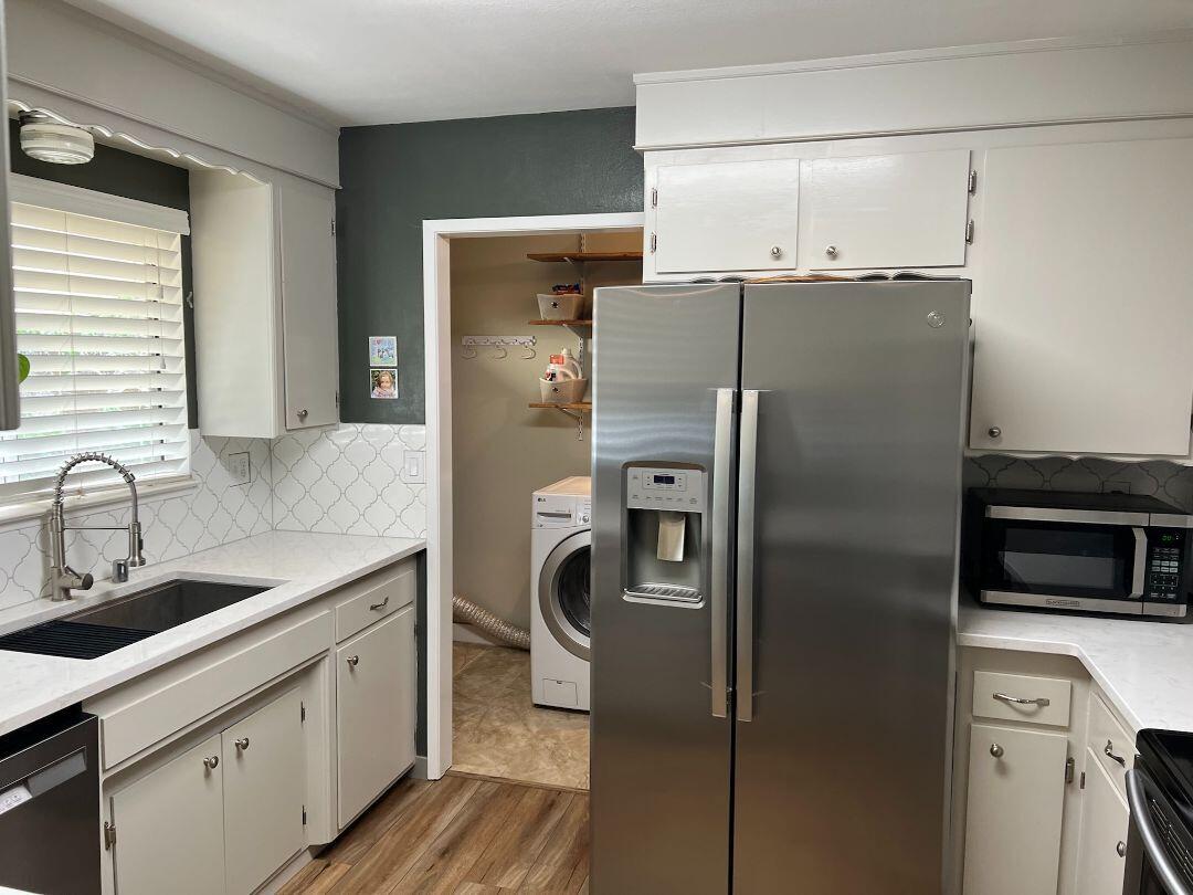 9733 Hidden Lane Palo Cedro, CA 96073 - Photo 10 of 63 a kitchen with stainless steel appliances a refrigerator sink and microwave