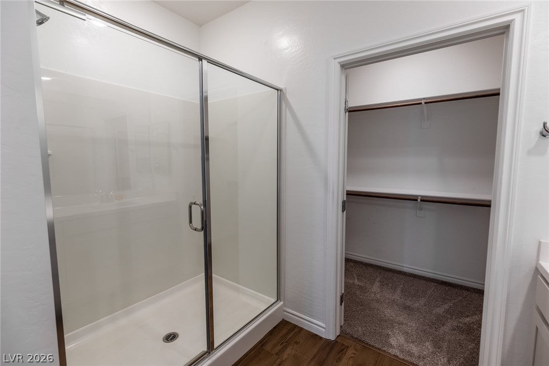 2555 Hampton Road, Unit 8206 Henderson, NV 89052 - Photo 15 of 35 This primary bathroom features a glass-enclosed shower and a spacious walk-in closet with ample storage.