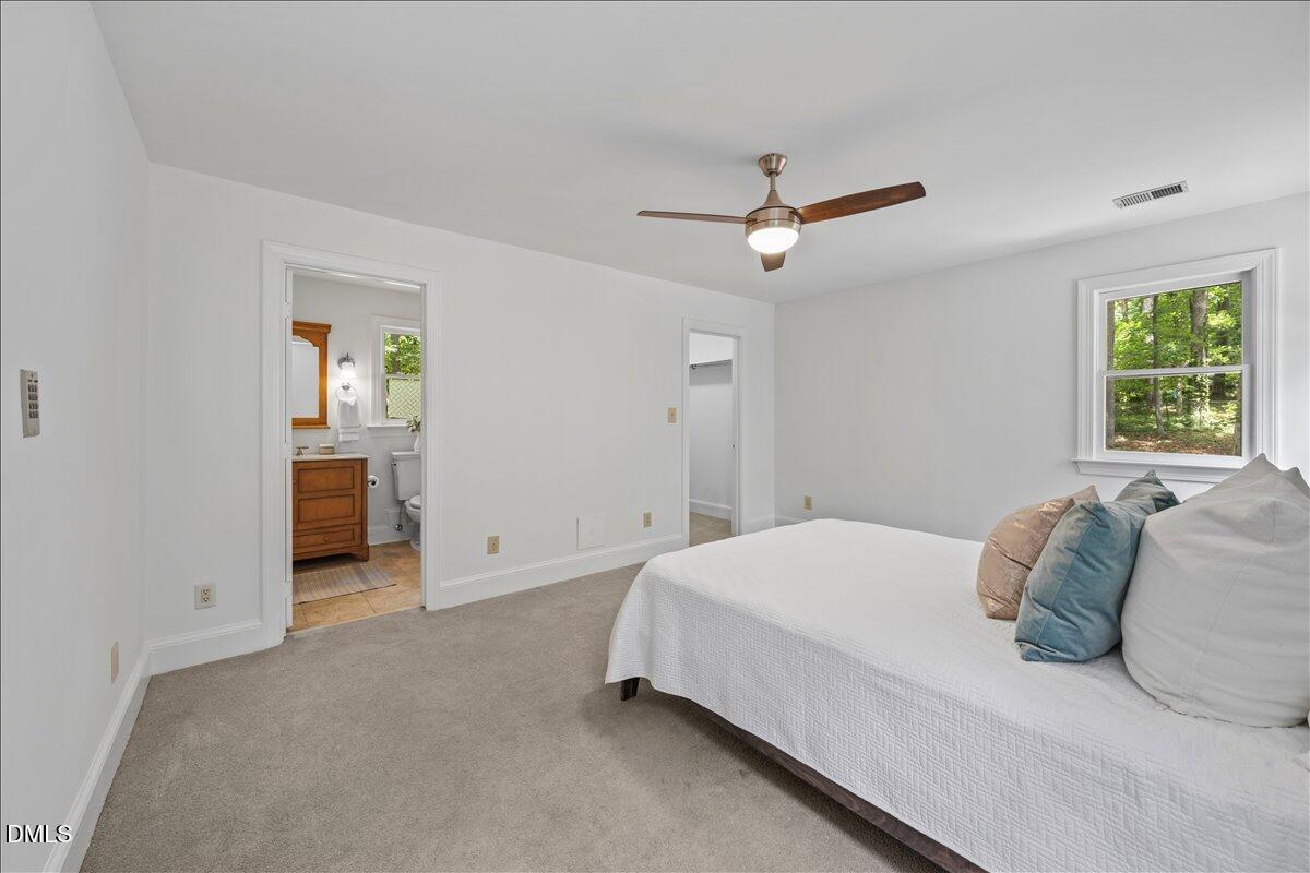 6516 Bakersfield Drive Raleigh, NC 27606 - Photo 33 of 59 a bedroom with a bed and a chandelier