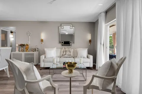 a living room with furniture and a potted plant