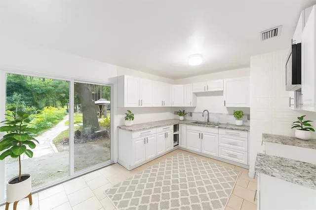 a backyard of a house with lots of green space and fountain