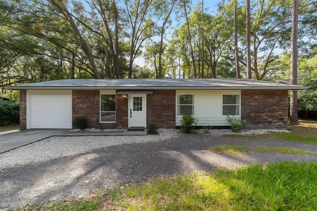 a kitchen with stainless steel appliances granite countertop a sink and dishwasher a stove top oven with white cabinets