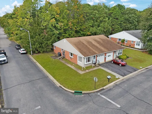 an aerial view of a house with swimming pool and patio