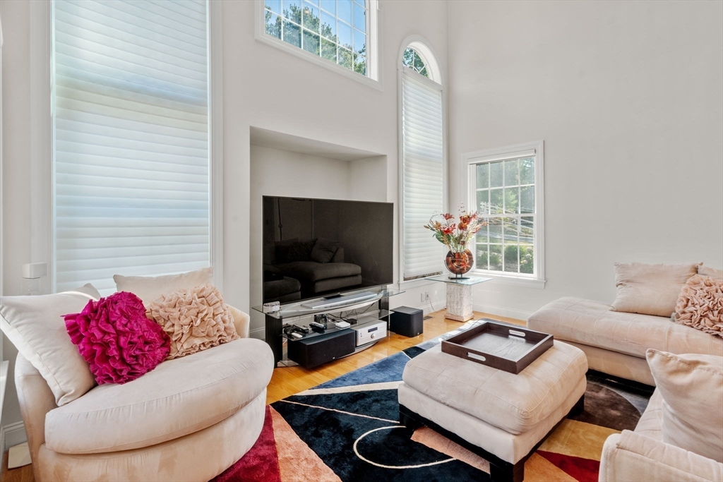 21 Whispering Lane Natick, MA 01760 - Photo 11 of 41 a living room with furniture and a flat screen tv