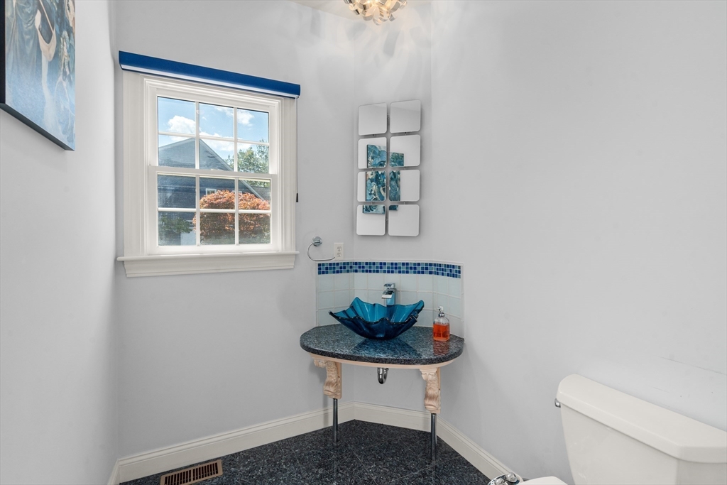 21 Whispering Lane Natick, MA 01760 - Photo 17 of 41 a bathroom with a sink a toilet and a window