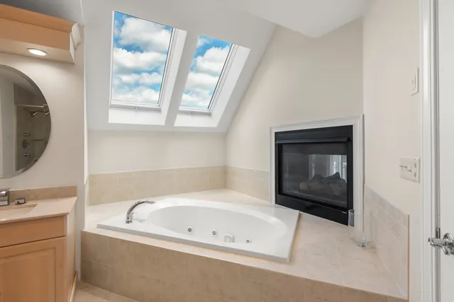 a bathroom with a bathtub sink and mirror