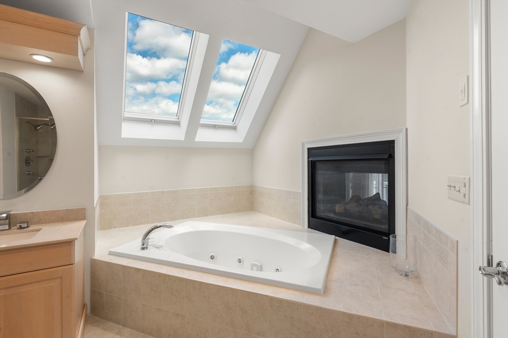 21 Whispering Lane Natick, MA 01760 - Photo 20 of 41 a bathroom with a bathtub sink and mirror