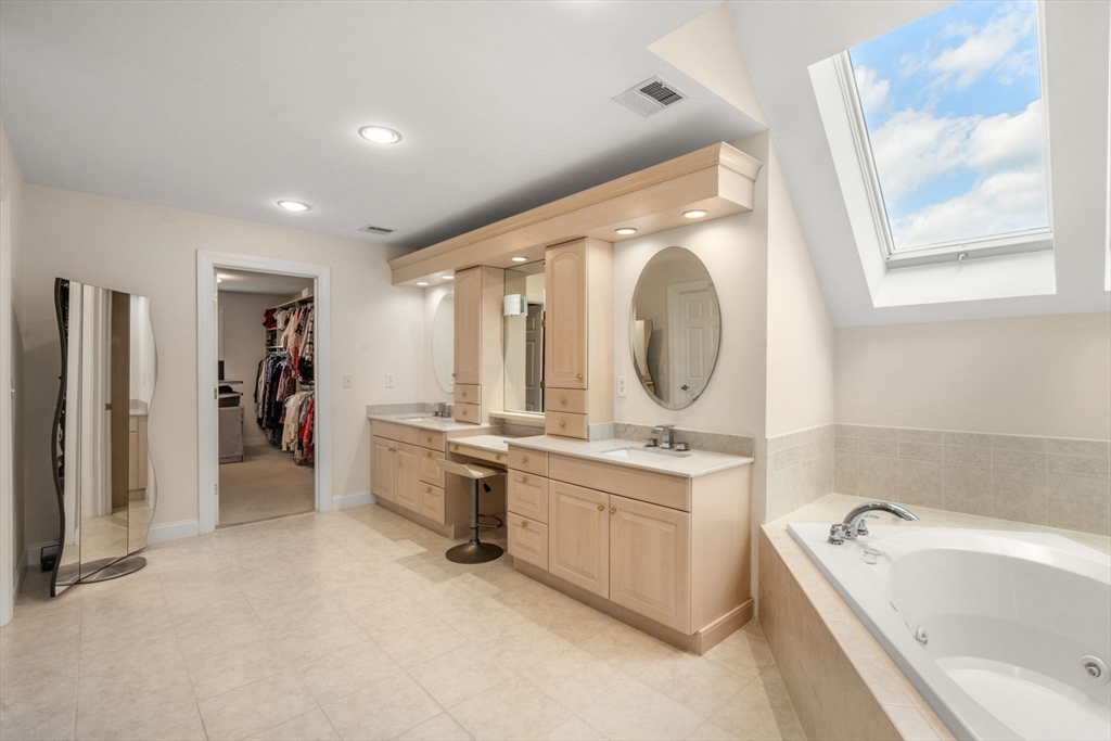 21 Whispering Lane Natick, MA 01760 - Photo 21 of 41 a large bathroom with a tub sink and mirror