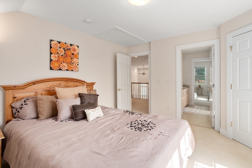 21 Whispering Lane Natick, MA 01760 - Photo 24 of 41 a bedroom with a bed and painting on the wall