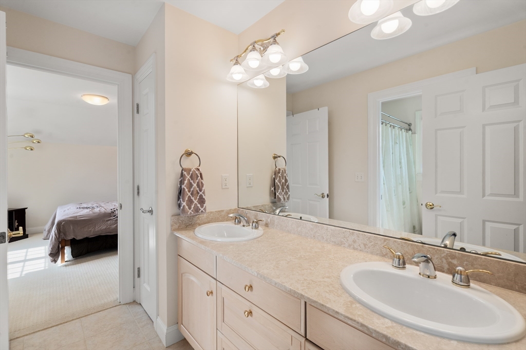 21 Whispering Lane Natick, MA 01760 - Photo 26 of 41 a en suite bathroom with a sink and a mirror