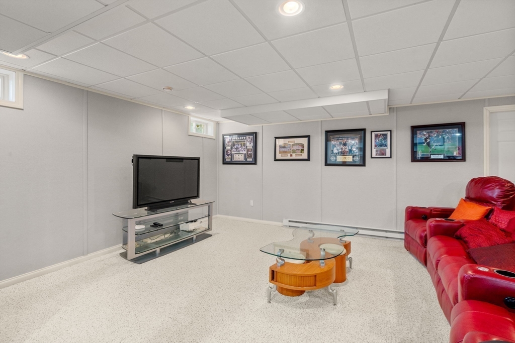 21 Whispering Lane Natick, MA 01760 - Photo 30 of 41 a living room with furniture and a flat screen tv