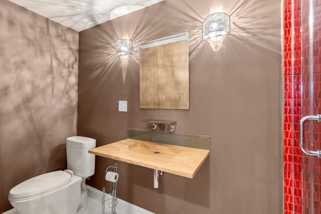 21 Whispering Lane Natick, MA 01760 - Photo 33 of 41 a bathroom with a granite countertop sink a toilet and a mirror