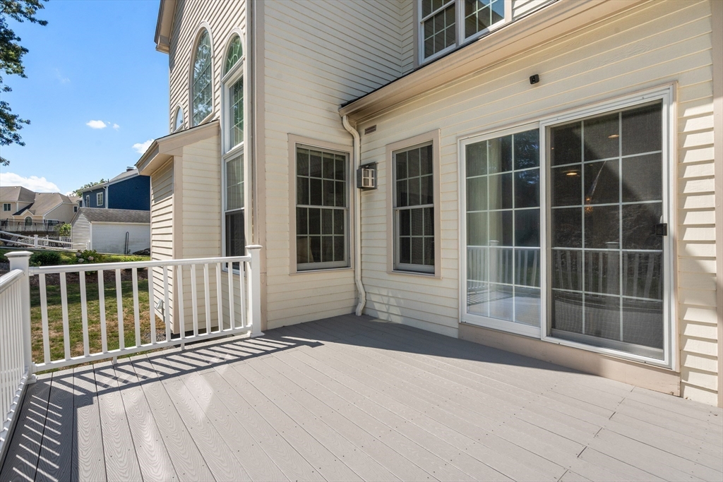 21 Whispering Lane Natick, MA 01760 - Photo 35 of 41 a view of a balcony with a large window and wooden floor