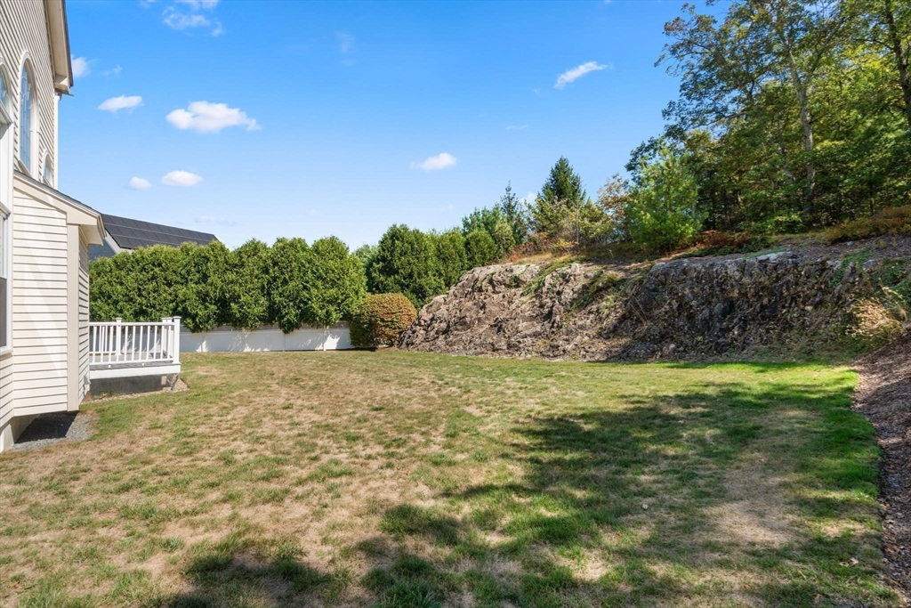 21 Whispering Lane Natick, MA 01760 - Photo 36 of 41 a backyard of a house with lots of green space