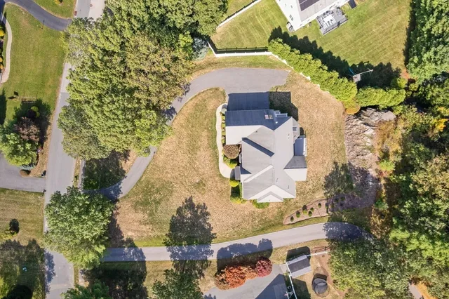 an aerial view of a house with a yard
