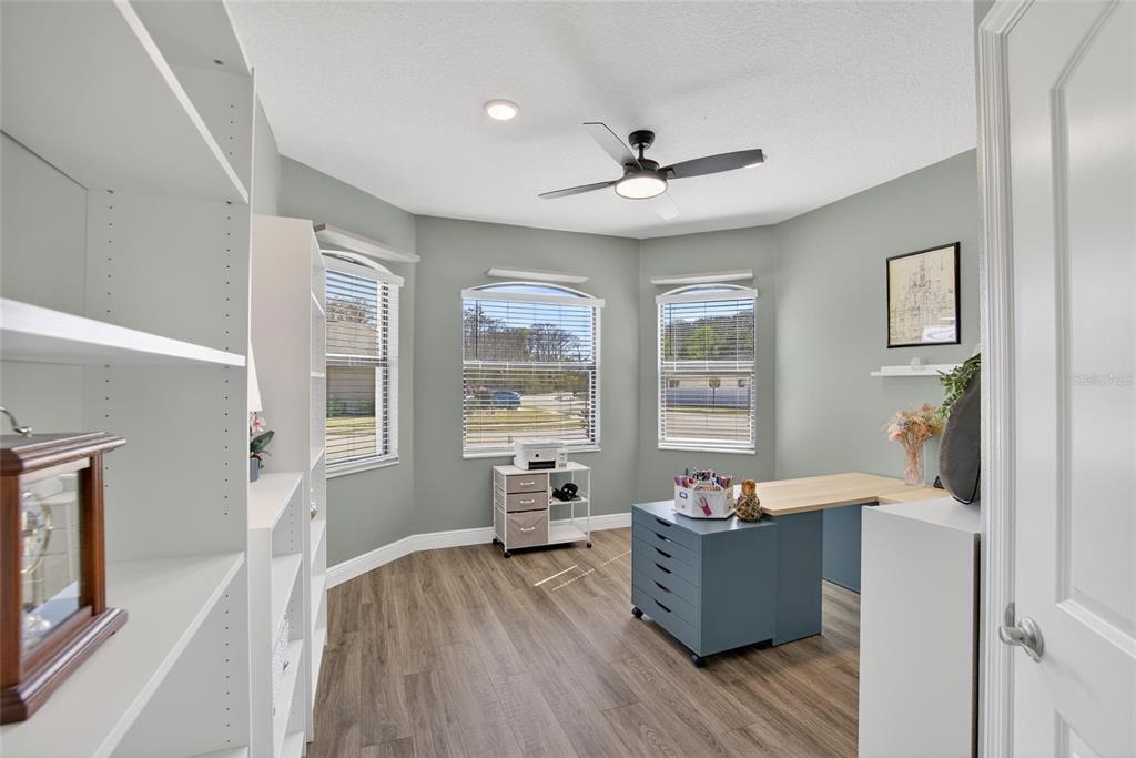 11439 Crowne Pointe Street New Port Richey, FL 34654 - Photo 12 of 50 a room with wooden floors and windows