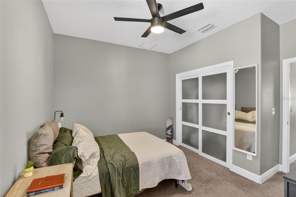 11439 Crowne Pointe Street New Port Richey, FL 34654 - Photo 15 of 50 a bedroom with a bed and a window
