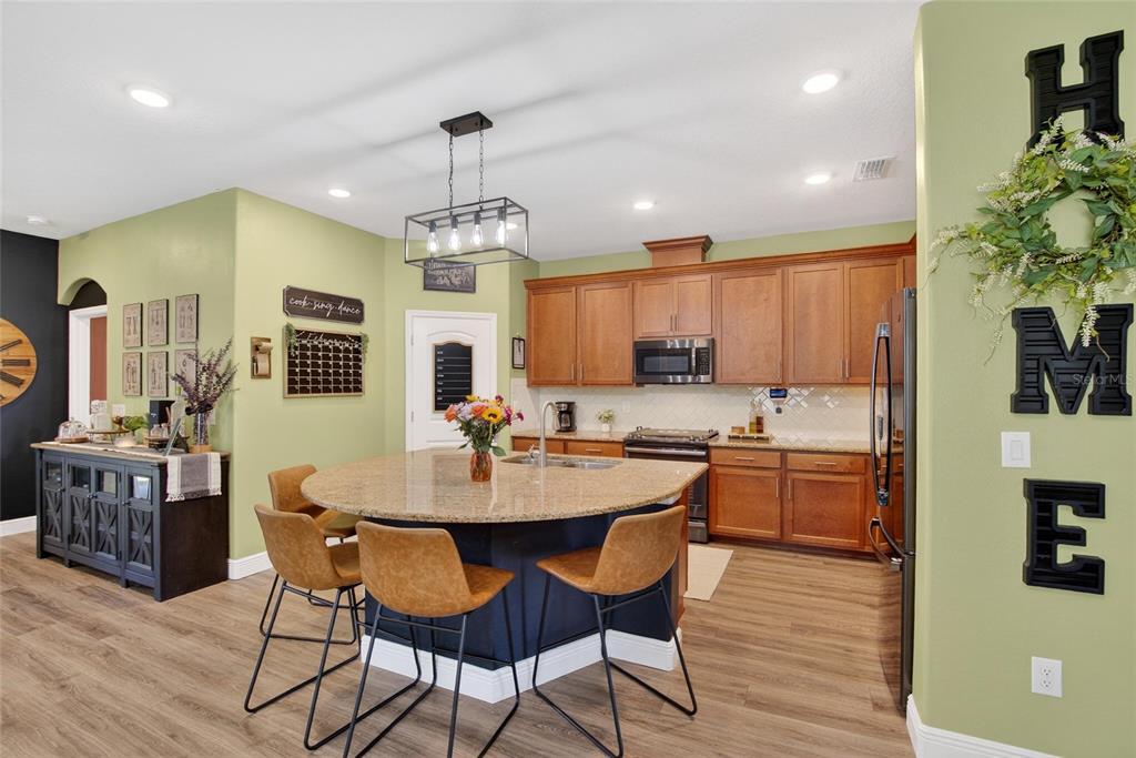 11439 Crowne Pointe Street New Port Richey, FL 34654 - Photo 18 of 50 a view of a dining room with furniture window and wooden floor