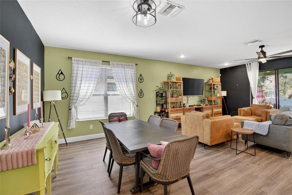 11439 Crowne Pointe Street New Port Richey, FL 34654 - Photo 23 of 50 a view of a dining room with furniture window and wooden floor