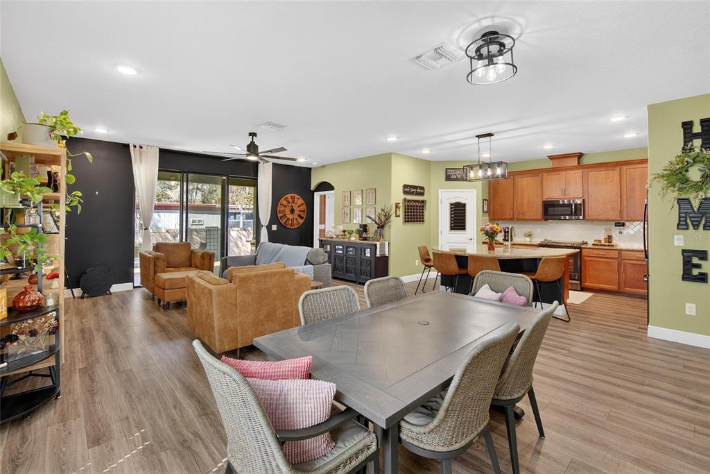 11439 Crowne Pointe Street New Port Richey, FL 34654 - Photo 25 of 50 a view of a dining room with furniture window and wooden floor