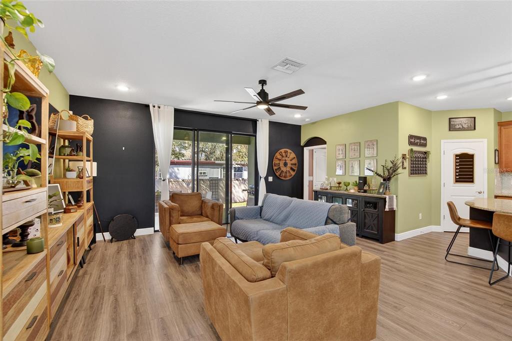 11439 Crowne Pointe Street New Port Richey, FL 34654 - Photo 26 of 50 a living room with furniture and a wooden floor