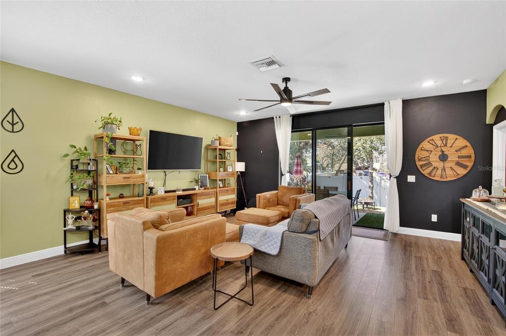 11439 Crowne Pointe Street New Port Richey, FL 34654 - Photo 27 of 50 a living room with furniture a rug and a flat screen tv
