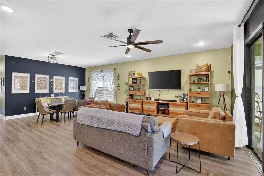 11439 Crowne Pointe Street New Port Richey, FL 34654 - Photo 28 of 50 a living room with furniture and a flat screen tv